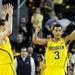 Michigan freshman Nik Stauskas and sophomore Trey Burke throw their hands up in the air after beating North Carolina State 79-72 at Crisler Center on Tuesday night. Melanie Maxwell I AnnArbor.com